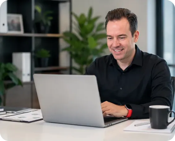 Employee working on laptop at desk.