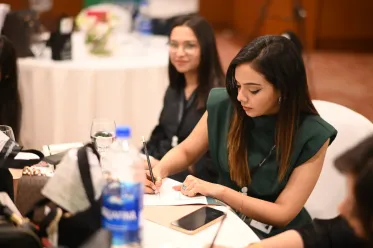 RepStack associates writing notes at a table during an event.