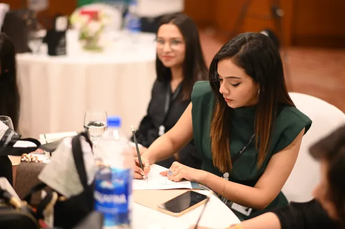 RepStack associates writing notes at a table during an event