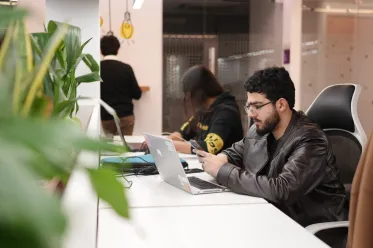 Employees working at desks in open office.