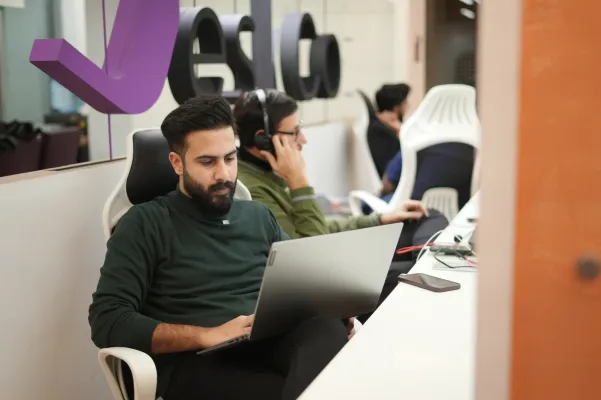 Associates working at desks in open office.